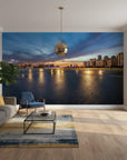 Embers On The Horizon cityscape wallpaper showing sunset skyline reflected in water on modern living room wall