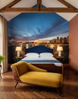 Embers On The Horizon cityscape wallpaper mural showing twilight skyline reflected in water behind bedroom bed