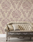 Mauve and cream Embroidered Floral Dream damask wallpaper behind tufted vintage sofa in elegant living room