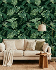 Emerald Jungle deep green tropical botanical wallpaper in a warm and inviting living room