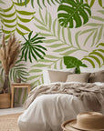 Vibrant tropical wallpaper featuring green monstera deliciosa and palm fronds in a peel-and-stick design.