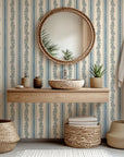 A self-adhesive wallpaper featuring botanical vines and vertical stripes in cream and blue tones (Ethereal Stripes design)
