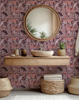 A peel and stick wallpaper featuring a faded, abstract lattice pattern overlaid with pink and maroon camouflage colors.