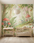 Whimsical Fern & Wonder wallpaper mural featuring red mushrooms, ferns, and forest flora in nursery setting