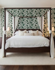 Foliage Fragments dark green tropical leaf wallpaper adding character to a cozy bedroom