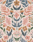 Soft folk-art floral wallpaper with stylized flowers, leaves, and berries in muted pink, sage green, dusty blue, and warm ochre on a pale blush background.