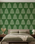 Forest green linen textured wallpaper with cream botanical fern motifs in modern bedroom setting