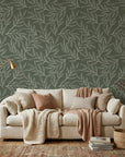 Sage green Forest Leaf wallpaper with cream botanical line drawings in cozy living room setting