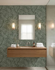 Sage green and cream Forest Leaf botanical wallpaper in modern bathroom with floating vanity