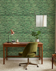 Forest Weave organic green abstract wallpaper as a feature wall in a bright home office