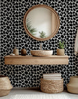 Abstract black and white, self-adhesive wall covering featuring a fragmented spot pattern, called Fractured Night