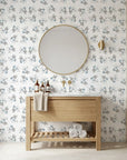 Blue and grey Frost Berry botanical wallpaper in modern bathroom with natural wood vanity
