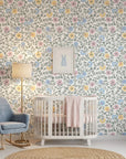 Pastel floral Garden Reverie wallpaper with pink, blue, and yellow blooms in serene nursery setting
