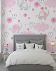 Adorable pink elephants floating among heart-shaped clouds on self-adhesive nursery wallpaper - Gentle Flutter