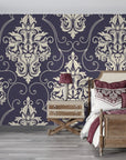 Navy and cream Gentlebotan damask wallpaper with ornate scrollwork in elegant bedroom setting
