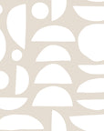Abstract geometric wallpaper with white organic shapes and half circles scattered across a warm beige background.