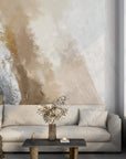 Gold and gray abstract brushstroke wallpaper on modern living room accent wall with neutral furnishings