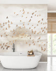 Golden Birds wallpaper with amber bird flock on cloudy sky backdrop in modern bathroom setting