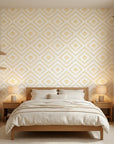 Cream and gold Golden Echo geometric diamond wallpaper on bedroom accent wall with warm natural lighting