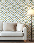 Hand painted geometric wallpaper with soft diamond shapes and angled brush strokes in sage green, olive, and warm ochre on a white background.