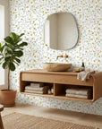 Yellow and sage Golden Tulip Vine peel and stick wallpaper in modern bathroom with natural wood vanity