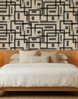 Gridded Scrawl black and beige abstract geometric square wallpaper adding character to a cozy bedroom