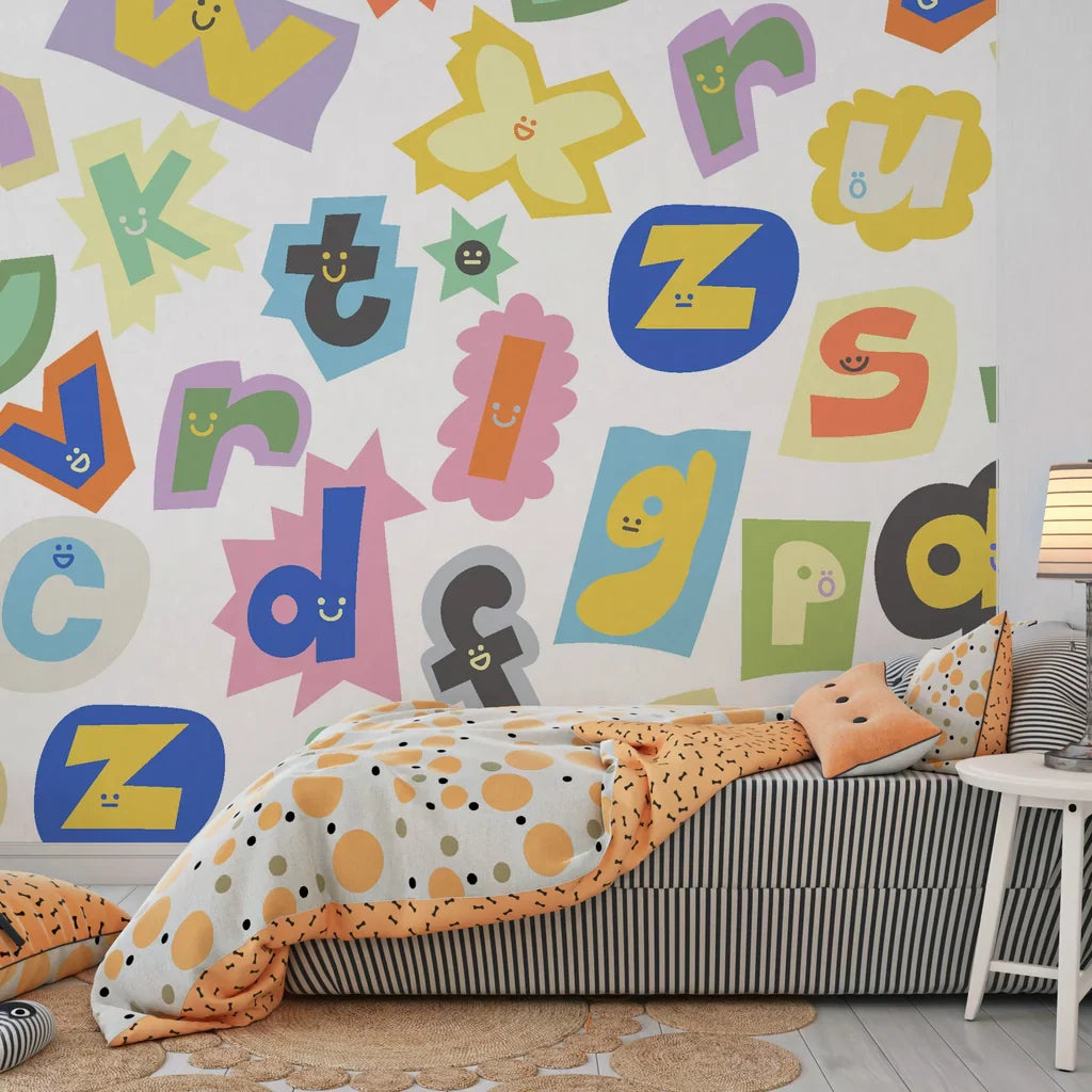 Multicolored collage of magazine letter cutouts arranged in a chaotic ransom note pattern on removable wallpaper - Happy Chaos