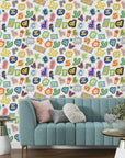 Bold pop art wallpaper displaying a dense mosaic of colorful newspaper-style letter clippings - Happy Chaos