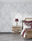 Silver and white damask Heirloom Rose Medley wallpaper in elegant bedroom with plum accents
