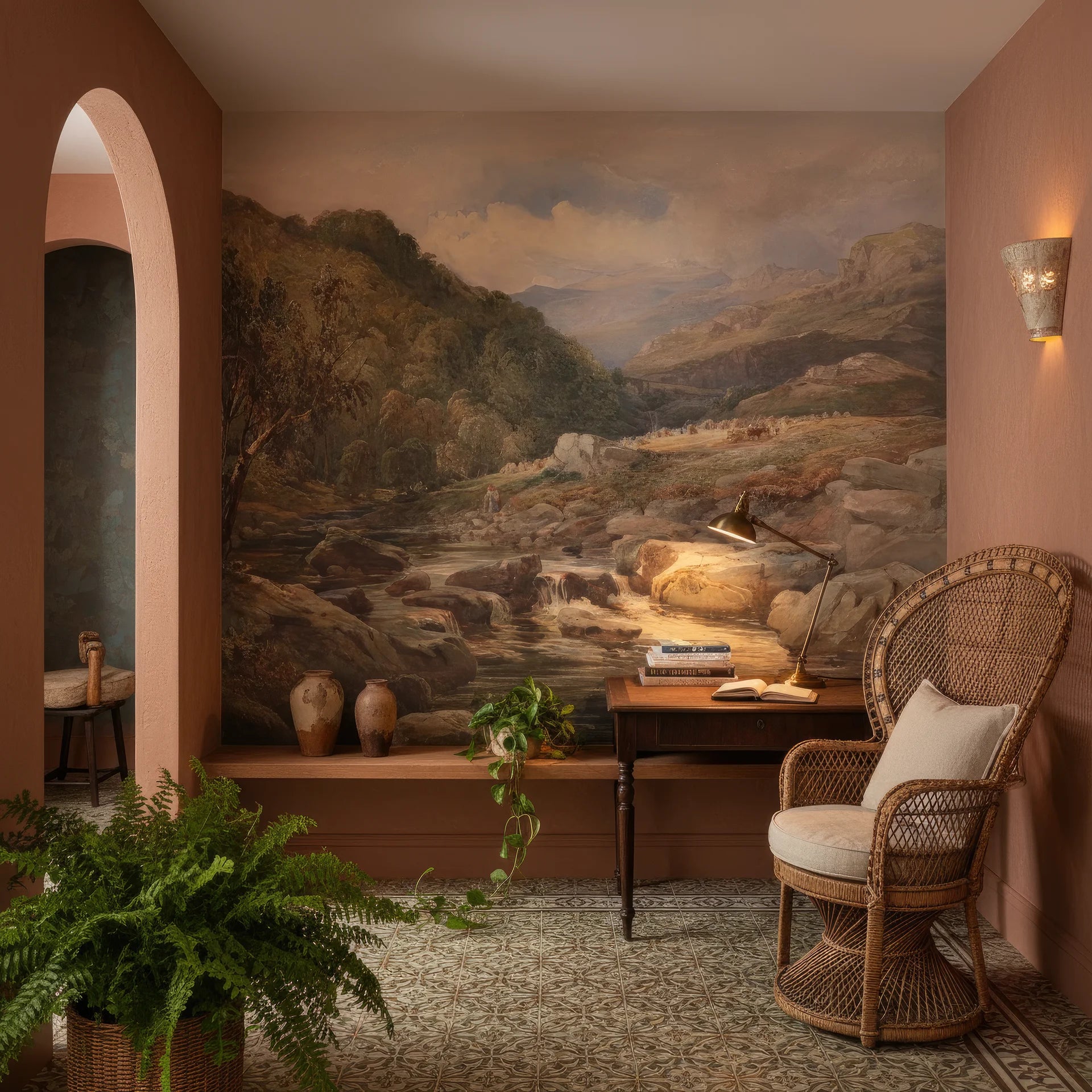 Hilltop Manor landscape mural wallpaper featuring mountain stream scene in terracotta-walled reading nook
