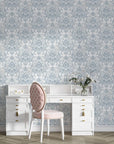 Honeyed Petal Mural damask wallpaper in soft blue and cream tones behind white vanity desk