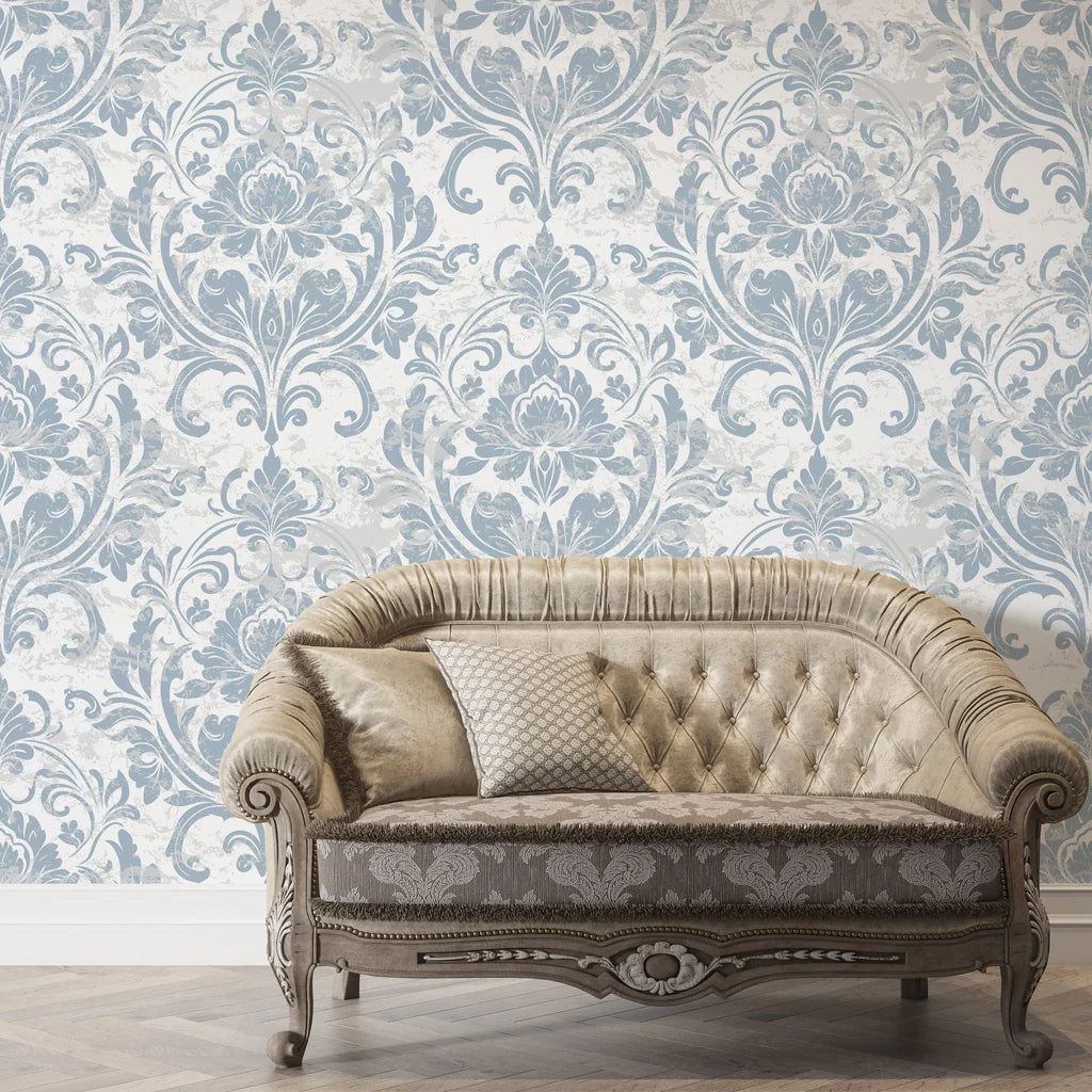 Blue and cream damask Honeyed Petal wallpaper on elegant living room wall with tufted sofa
