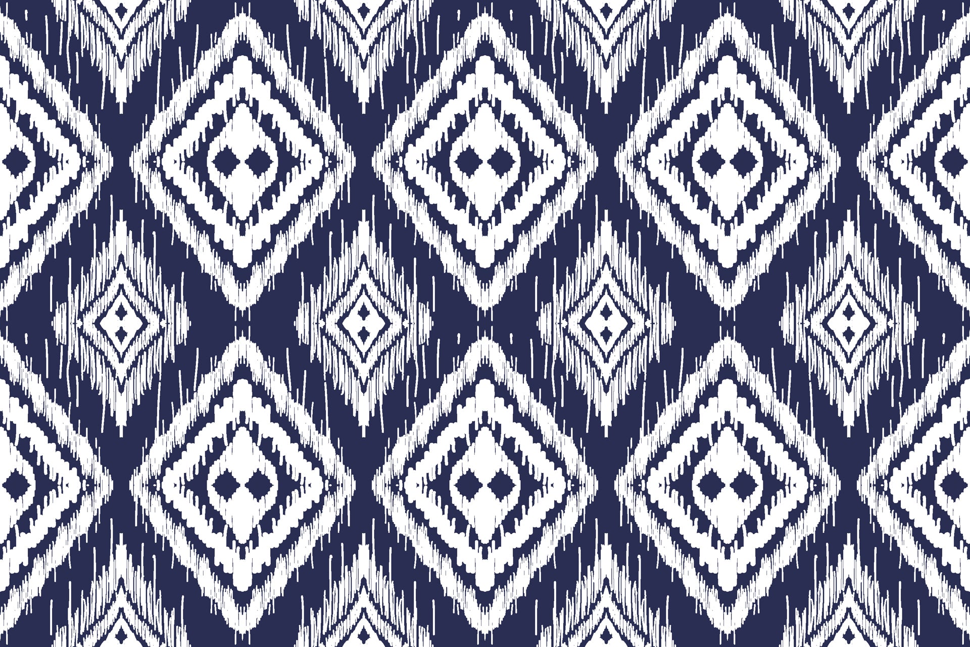 Navy blue ikat style wallpaper with repeating white diamond motifs and textured hand painted edges.