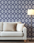 Navy blue ikat style wallpaper with repeating white diamond motifs and textured hand painted edges.