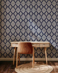 Navy blue ikat style wallpaper with repeating white diamond motifs and textured hand painted edges.