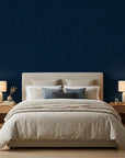 Indigo Undertow deep navy blue swirling abstract wallpaper in a warm and inviting living room