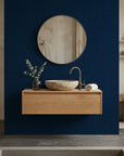 Indigo Undertow deep navy blue swirling abstract wallpaper as a feature wall in a bright home office
