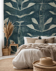 Teal blue hand painted wallpaper with repeating abstract leaf shapes and layered textured brush strokes.