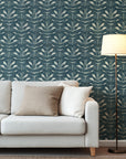 Teal blue hand painted wallpaper with repeating abstract leaf shapes and layered textured brush strokes.