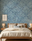 Textured blue and gray Indigo Weave peel and stick wallpaper in modern coastal bedroom with natural wood furnishings