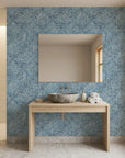 Blue and white Indigo Weave textured wallpaper surrounding modern bathroom mirror with natural wood vanity