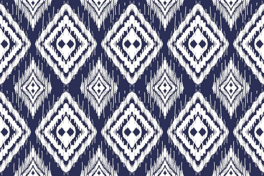 White diamond pattern repeating on navy blue, ikat-inspired wallpaper featuring textured, hand-painted edges