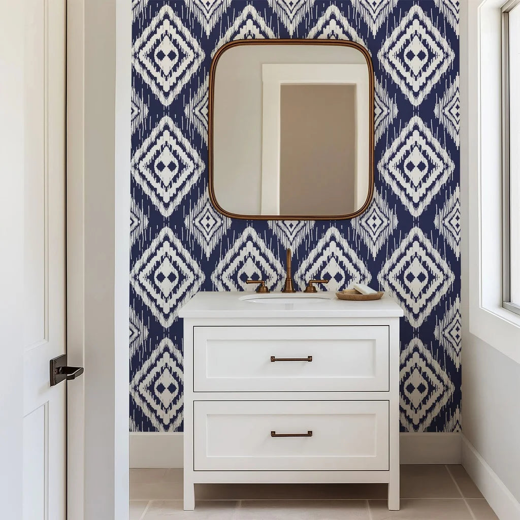 Textured, hand painted borders surround the pattern on this midnight blue wall paper, displaying repeating pale rhomboid designs in an ikat style