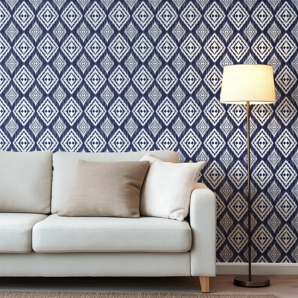 Dark blue wallpaper featuring a repeating ikat diamond motif and distinct textured edges that appear hand-painted