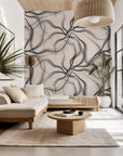 Wallpaper featuring the abstract pattern 'Ink Rivers,' characterized by flowing lines of black and beige ink
