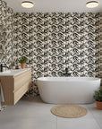 Ink Thicket bold black botanical wallpaper creating ambiance in a serene bathroom