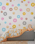 Removable wallpaper featuring a bright spectrum of whimsical animal footprints in a seamless pattern - Joyful Jaunts
