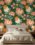 Linen textured Jungle Solstice wallpaper featuring orange and pink florals on deep green background