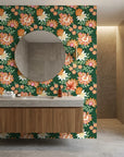 Green and coral Jungle Solstice floral wallpaper behind modern bathroom vanity with round mirror