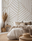 Neutral beige wallpaper with repeating hand drawn geometric blocks made of white linear brush strokes.